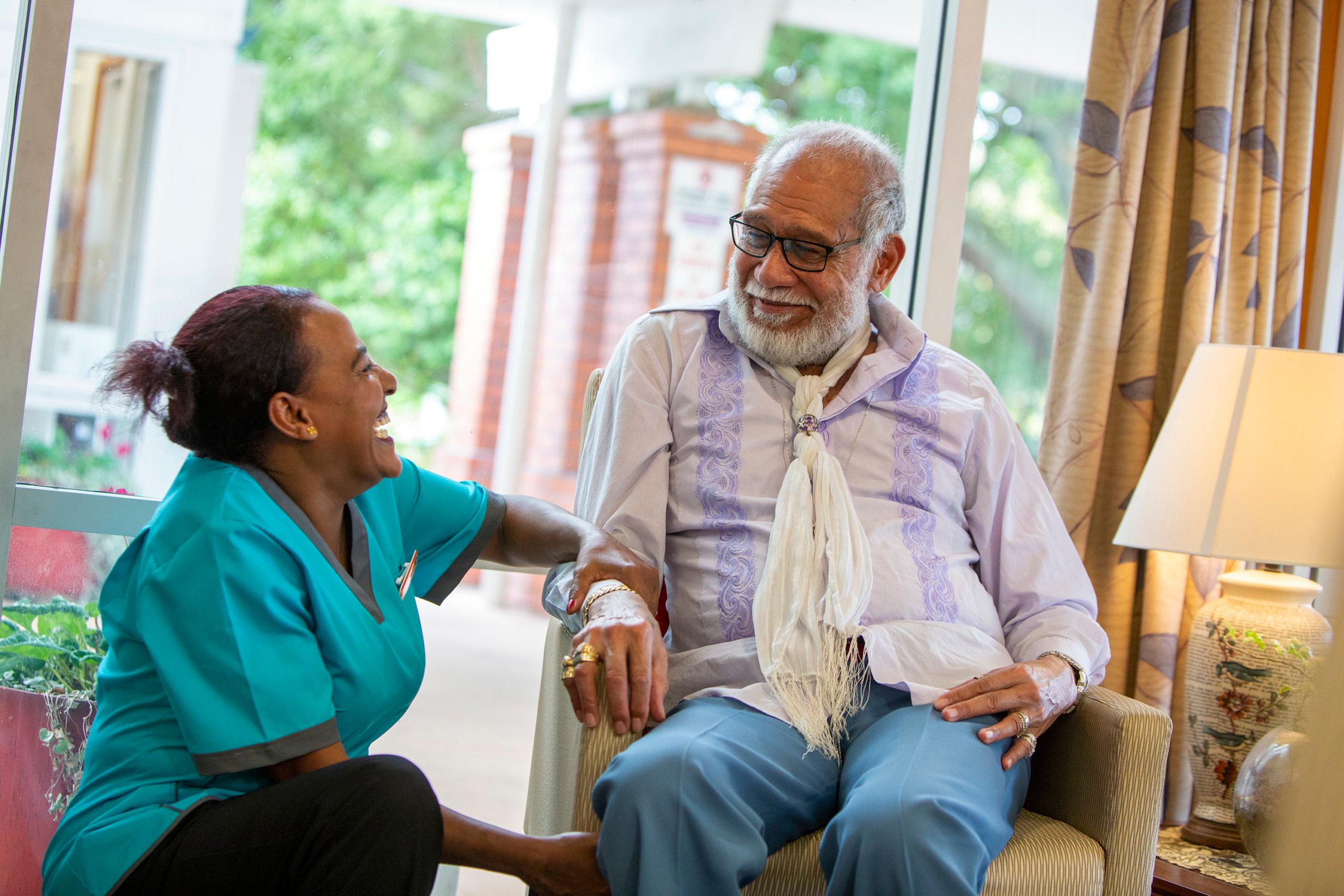 Care resident laughing with Healthcare Assistant