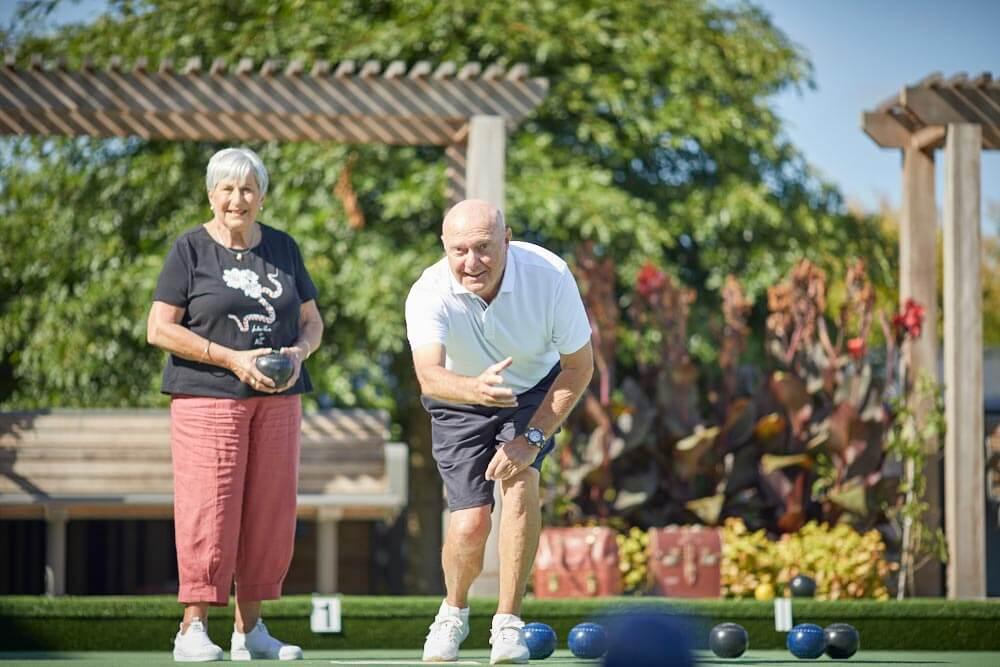 Two residents playing lawn bowls.