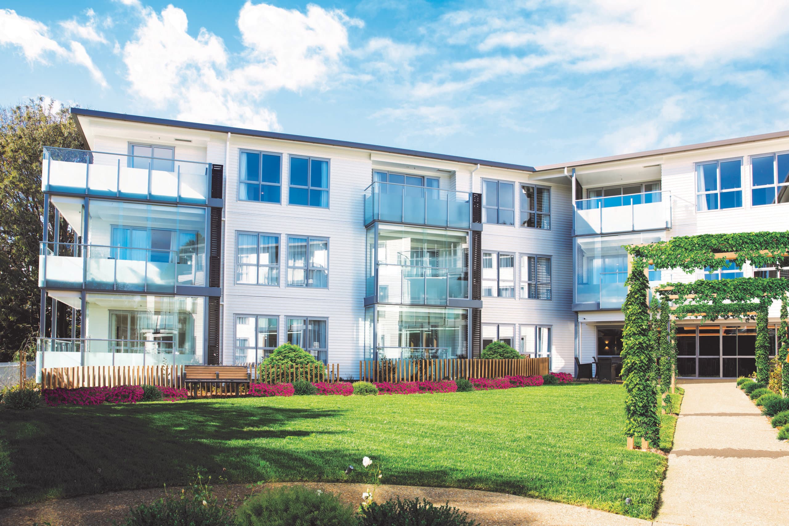 Lady Allum outside gardens with trellis