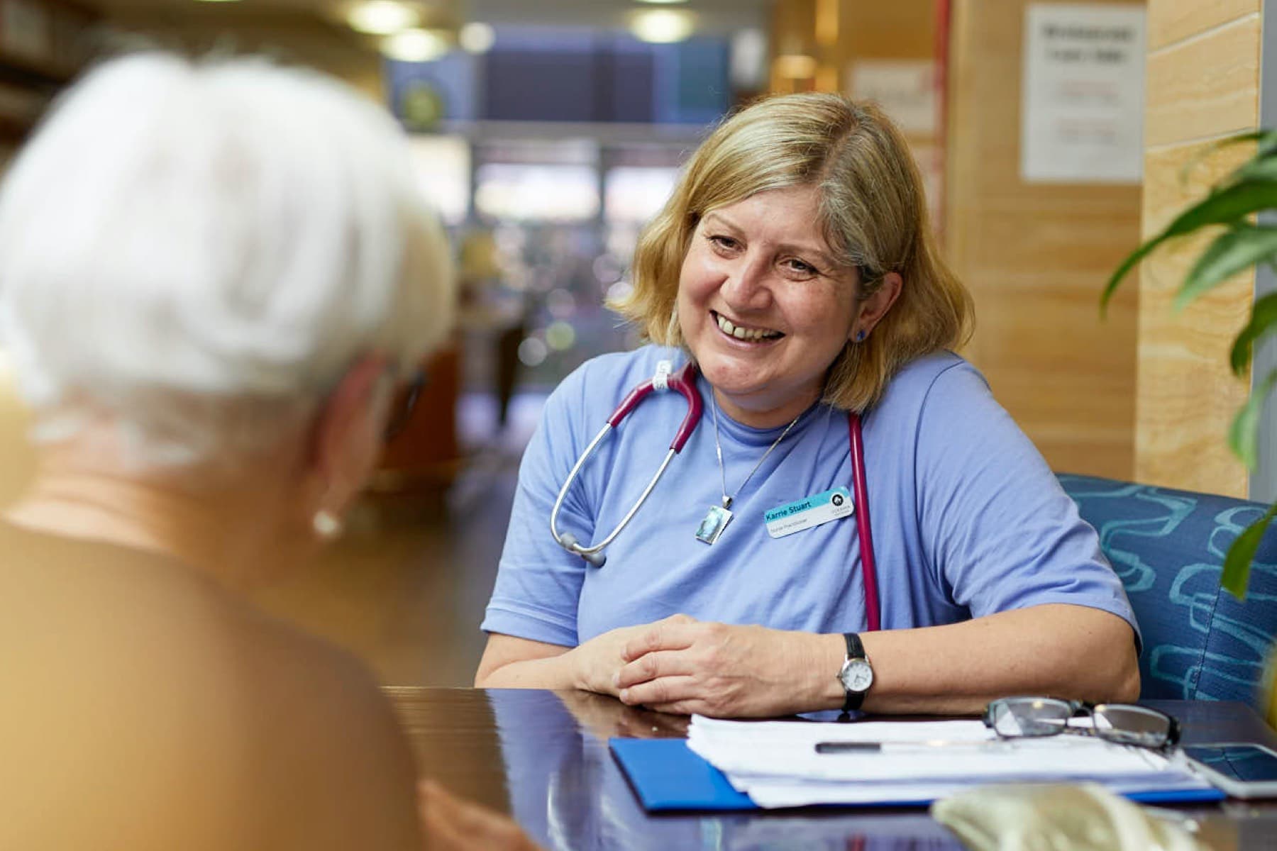 Oceania nurse discussing with a resident